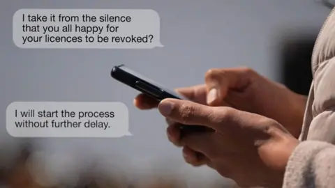 A photograph shows a person's hands holding mobile phone, as if they were reading messsages. Two messages in speech bubbles appear on the left-hand side of the photograph. The first says: "I take it from the silence that you all happy to have your licences revoked?" The second says: "I will start the process without further delay."