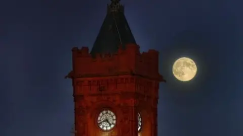 Nadezna The supermoon can be seen behind the Pierhead Clock, famous Cardiff landmark.