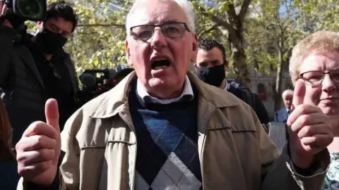 Former post office worker Noel Thomas, who was convicted of false accounting in 2006, celebrates with his daughter Sian outside the Royal Courts of Justice, London, after having his conviction overturned by the Court of Appeal