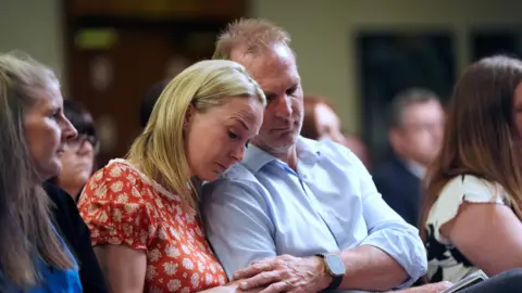 PA Media Sarah and Jack Hawkins during a press conference at Crowne Plaza Hotel Nottingham, following the publication of former midwife Donna Ockenden's independent report into maternity care 