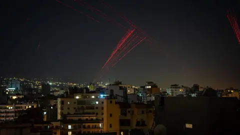 Gunfire is fired into the sky from Beirut's southern suburbs in the early hours of April 17, 2026, as residents celebrate the start of a 10-day ceasefire that took effect at midnight. 