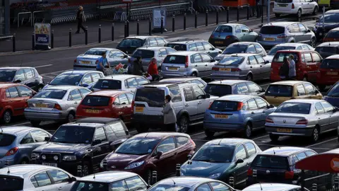 An assortment of cars parked in a car park 