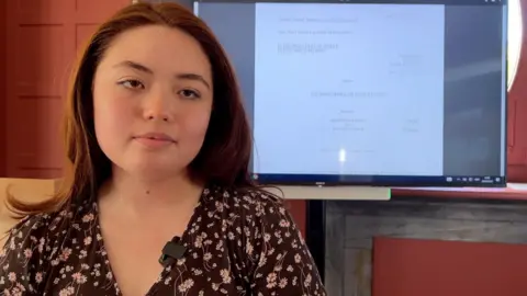 Martina Hudson who is an undergraduate at Reading University, pictured in front of a screen showing the judgement in the case of Bates v The Post Office