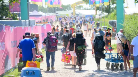 Getty Images Festival-goers heading into the Isle of Wight Festival on Thursday