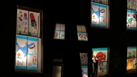 Images of a window display featuring sea life animals such as sharks and dolphins.