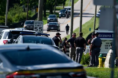 Police stand outside of the Richmond Road Baptist Church in Lexington, Kentucky after a deadly shooting 