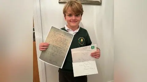 Family Handout Cadell holding both letters
