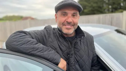Costa Nicolaou with his car. He successfully claimed off Essex County Council after he said a pothole caused more than £4,000 worth of damage to his car