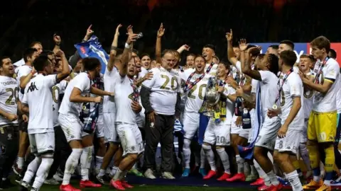 Tim Goode/PA Wire Leeds United team celebrate title win