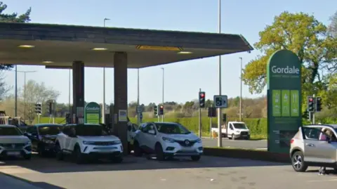 Google Gordale petrol station showing a number of cars lined up for fuel and a large green sign with which says Gordale in white writing.