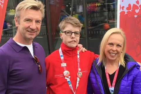 Supplied Callum Mills standing next to Jayne Torville and Christopher Dean wearing warm clothes.