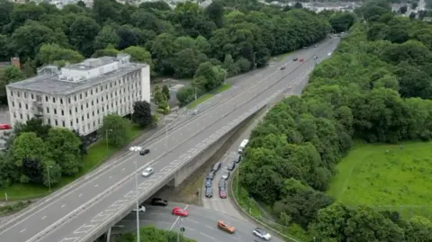 An aerial shot of Outland Road leading up to Manadon roundabout and the ancient woodland that sits alongside the road