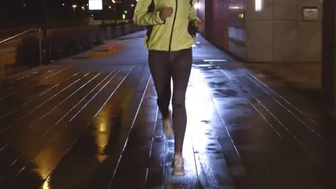 Getty Images woman running at night