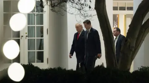 Getty Images Mr Trump is seen walking with Mr Porter at the White House in December 2017