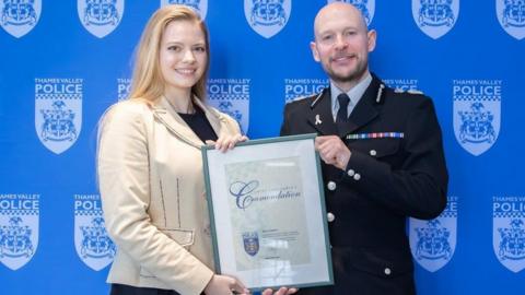 Marie Gumpert being presented with a certificate by Chief Constable Jason Hogg