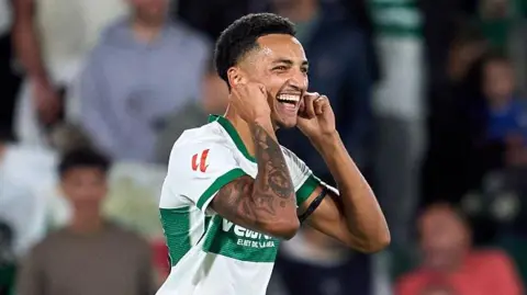 Alvaro Rodriguez pulls his ears after scoring for Elche