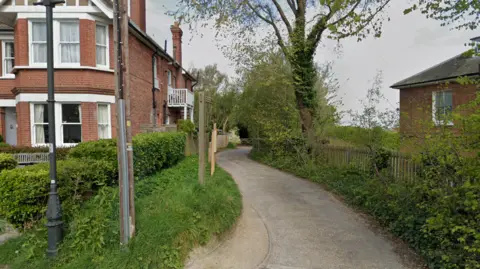 Google A path leading up to a park.
