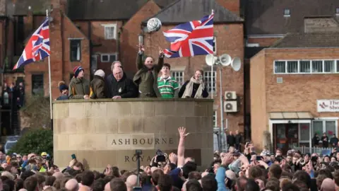 Reuters Shrovetide football being thrown into crowd from plinth