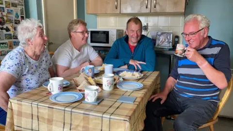 BBC Left to right: Eira, Sian, Neil Hudgell and Noel at the Thomas’s home in Gaerwen