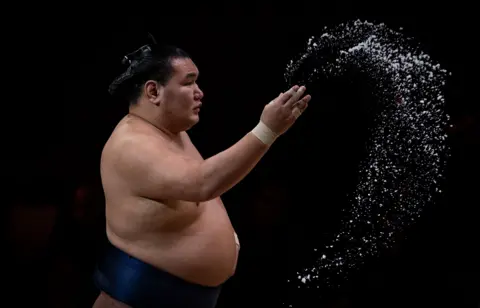 Getty Images Hoshoryu throws salt during day one of The Grand Sumo Tournament at Royal Albert Hall