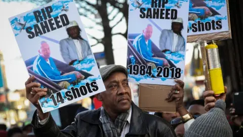 Getty Images The victim's father, Eric Vassell, joined the protesters