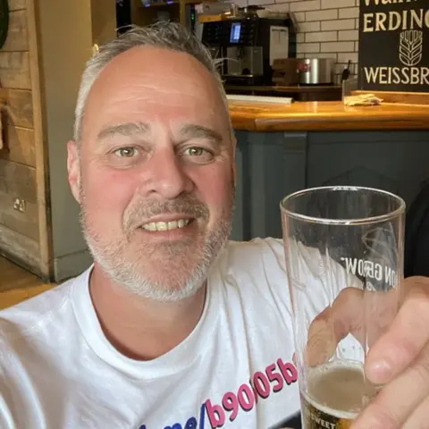 John Tennyson John Tennyson holding a pint glass