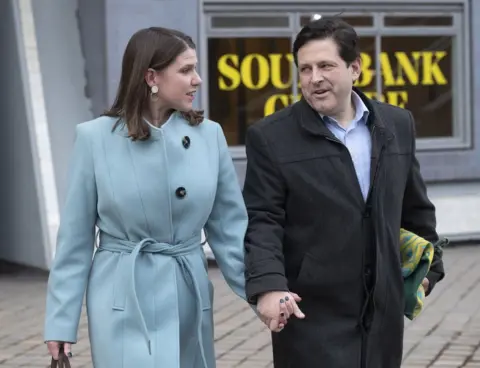 Facundo Arrizabalaga / EPA Jo Swinson and husband Duncan Hames leave the Southbank centre in London,