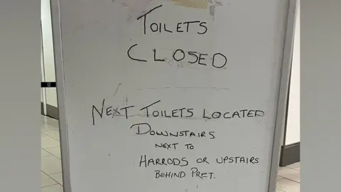 Sarah Houchin A whiteboard which says "TOILETS CLOSED" on it.
