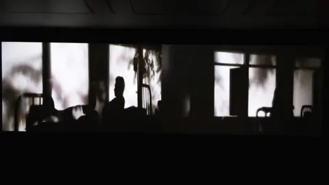 POLLY THOMAS Two figures in different rooms begin to infiltrate each other's dreams, in Weerasethakul's two-channel video installation