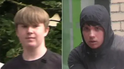 Humberside Police Man with blond hair wearing a black T Shirt and a man in a black rain jacket with the hood pulled up