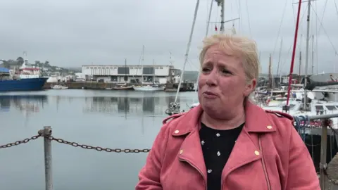 Michaela Badge stands by a harbourside