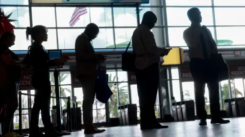 People walking in front of a terminal building