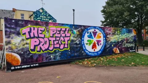 Street art on Peel Street in Hull, which includes the project's logo in bright colours.