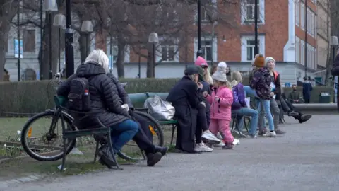 Families enjoy the fresh air in a Stockholm park