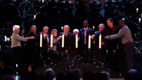 PA Media Eva Clarke BEM, Var Ashe Houston, Daniela Abraham , Manfred Goldberg BEM, Mala Tribich MBE, Arek Hersh MBE, Yvonne Bernstein, Appolinaire Kageruka, Ernest Simon, Dzemal Paratusic and Isam Agieb