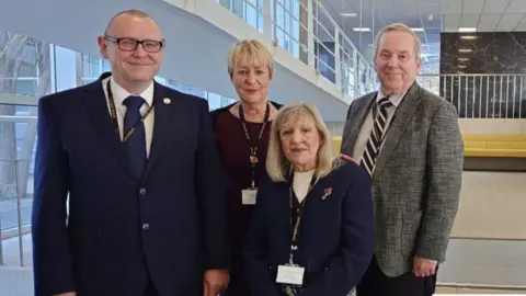 BBC Councillors O'Connor, Thomason-Kenyon, Knight, and Parsonage standing together in the atrium at County Hall in Truro.