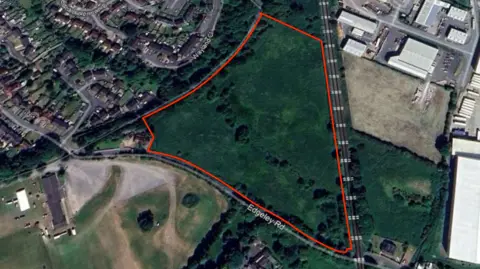 Shropshire County Council an aerial view of land demarcated by a red line showing the site affected by the housing development application. 