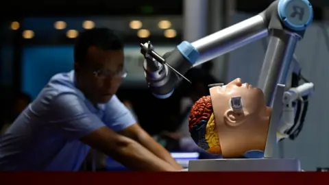 Getty Images A robotic arm for brain surgery is seen at the 2019 World Robot Conference in Beijing on August 20, 2019.