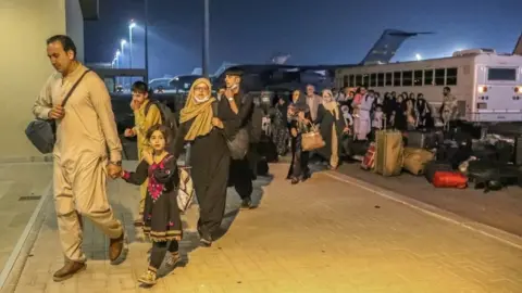 Reuters Evacuees from Afghanistan arrive at Al-Udeid airbase in Doha, Qatar (17 August 2021)