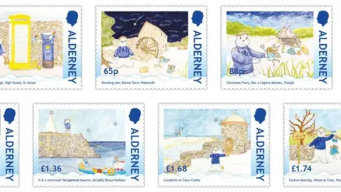 Guernsey Post Picture fully shows four of the Alderney Christmas stamps and parts of another three. Each one has 'Alderney' written down the right hand side under King Charles III's head. The illustrations show a snowman wearing a blue top with a blonde hedgehog and shooting star at Bonne Terre Watermill (65p), with a fairy at a Christmas party at Roc a l'opino dolmon Tourgis (88p), looking at a navigational beacon at old jetty, Braye Harbour (£1.36) and with lovebirds at Essex Castle (£1.68).