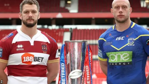 PA Wigan captain Sean O'Loughlin and Warrington's Chris Hill with the Super League trophy at Old Trafford