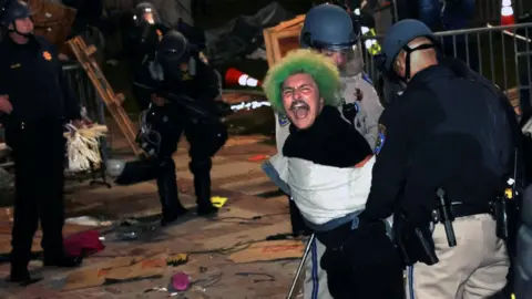 Police officers arrest a pro-Palestinian protester after an order to disperse was given at UCLA early Thursday morning