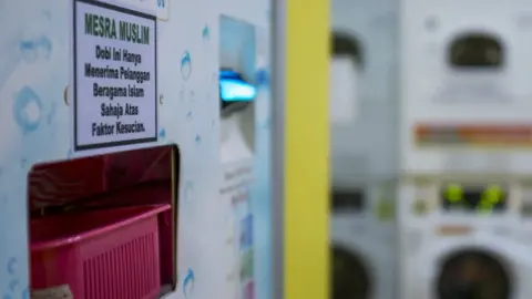 The Malaysian Insight/Hasnoor Hussain Washing machine with a sticker saying it was to be used by Muslims only for "purity"