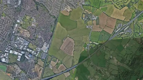 Google Whaddon Grange area comprising of large agricultural fields surrounded by buildings and motorways