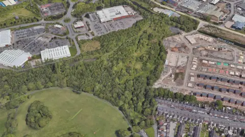 An aerial view of a large expanse of woodland between urban areas on a map.