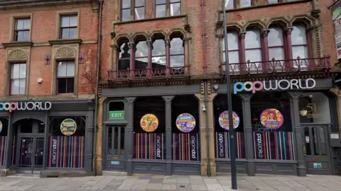 Exterior of a building with signs across the front reading Popworld