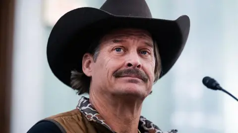 Kid Rock is seen wearing a cowboy hat