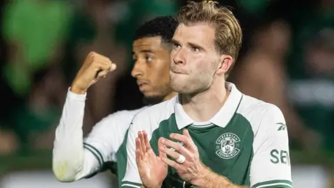Chris Cadden applauds the Hibs crowd after Thursday's win over Malisheva