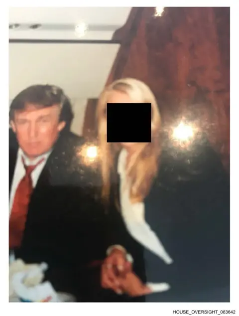 House Oversight Committee One image showed him standing next to a woman whose face has been redacted.