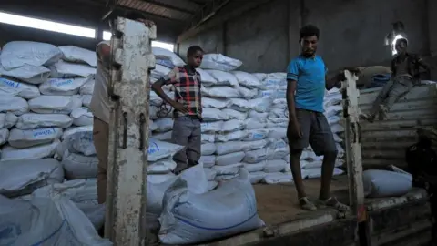 Reuters Several men unload food aid in Ethiopia